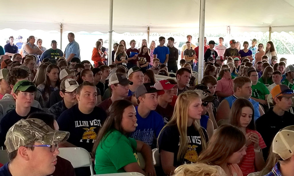 Students in a livestock judging competition crowd