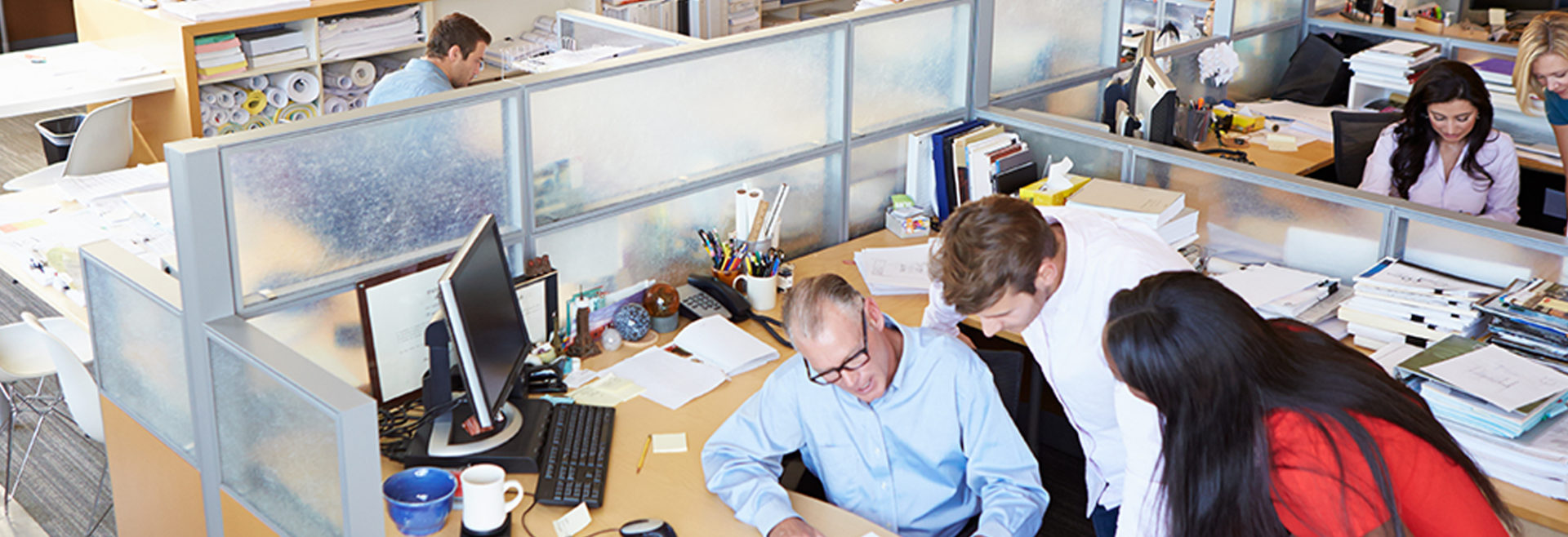 many people talking in an office environment