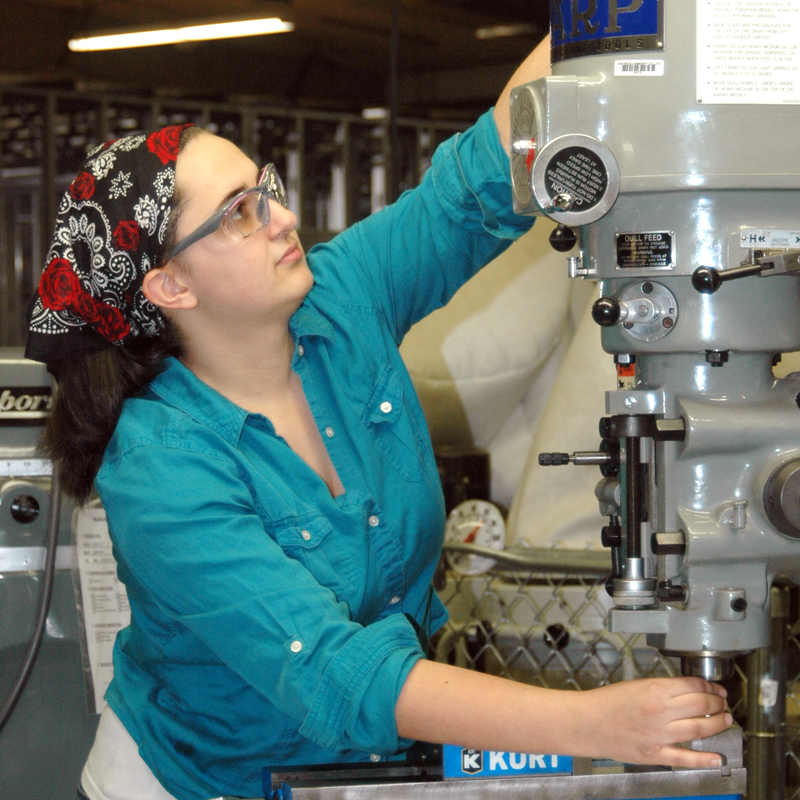 student working with a machine