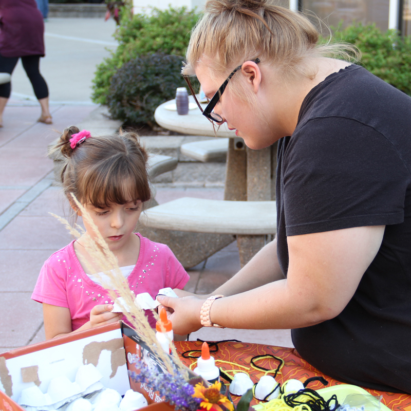 JWCC student making a craft with a young child