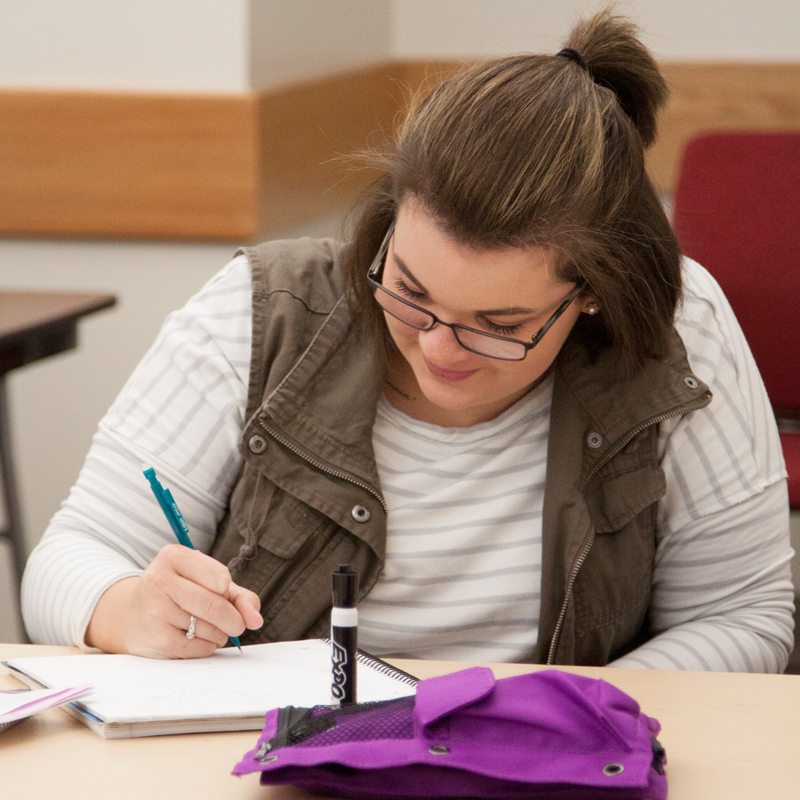 Student writing in her notebook