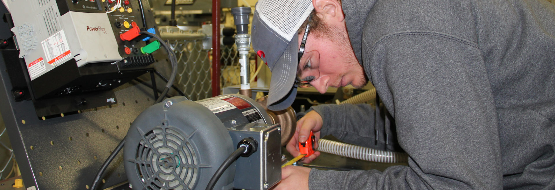 Student using a measuring tape to measure something