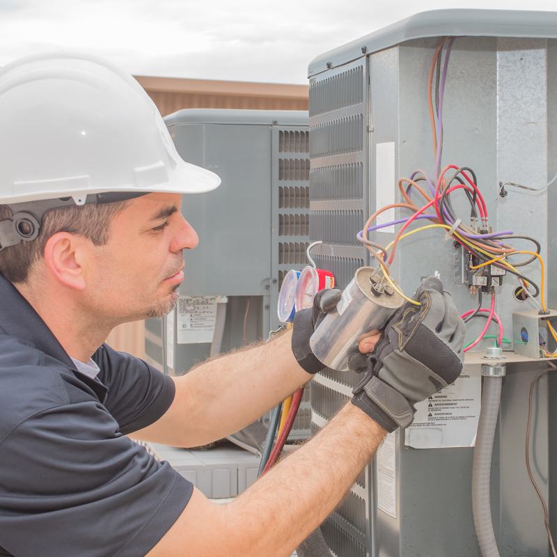 man connecting wires on a unit