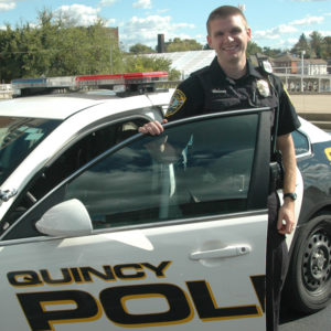 Quincy Police officer standing with car door open