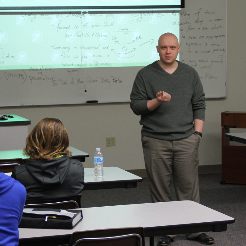 man standing in a classroom talking