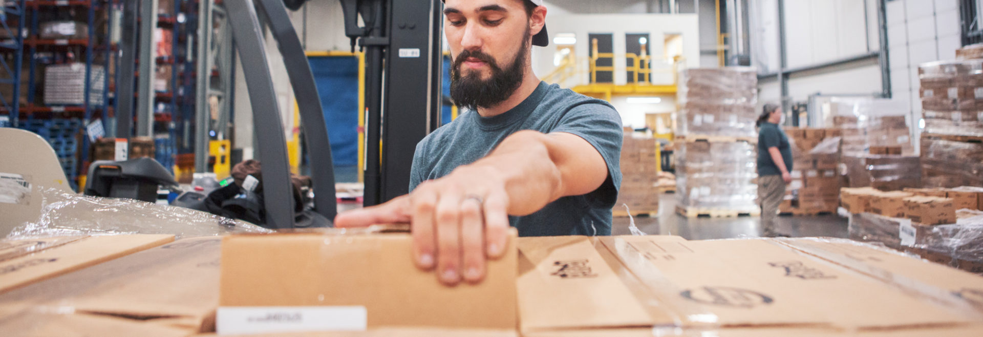 man pulling a box in a warehouse