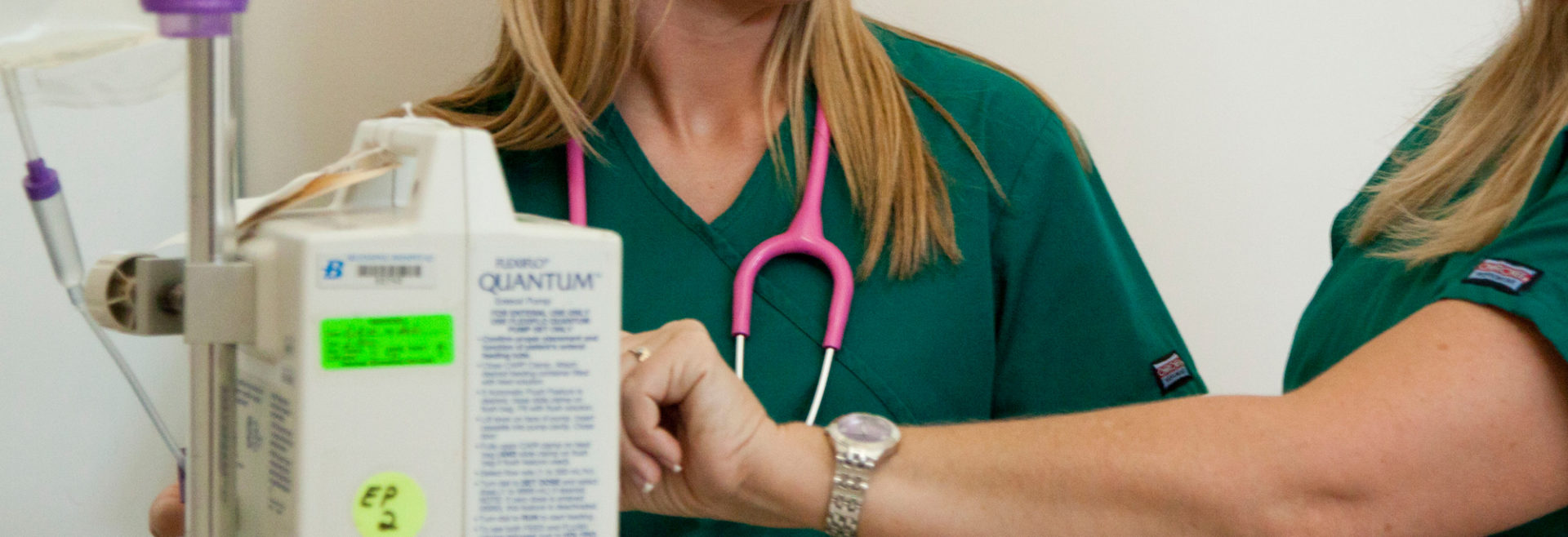 Nursing students at an IV pump