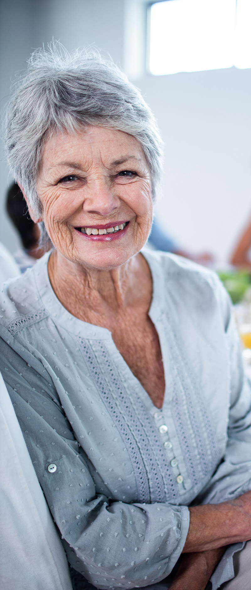 Portrait of senior woman sitting at dinning table RSVP senior citizen