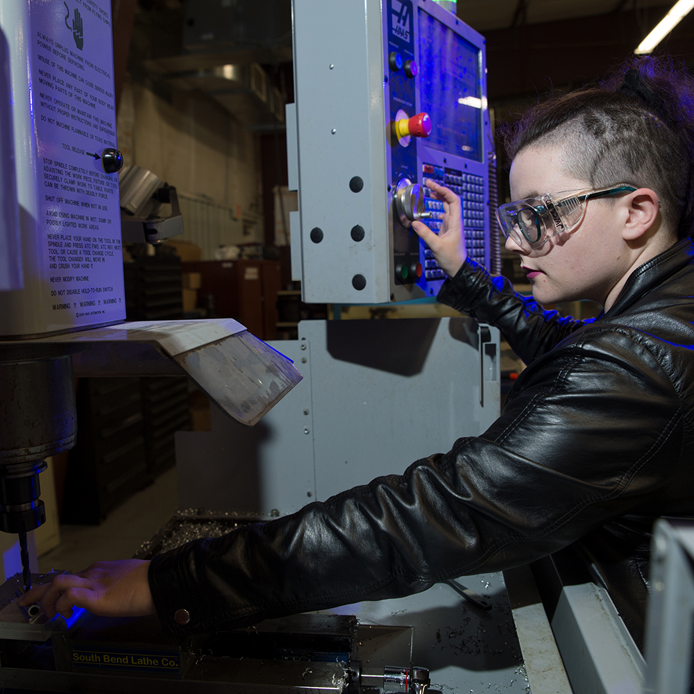 student working on machinery