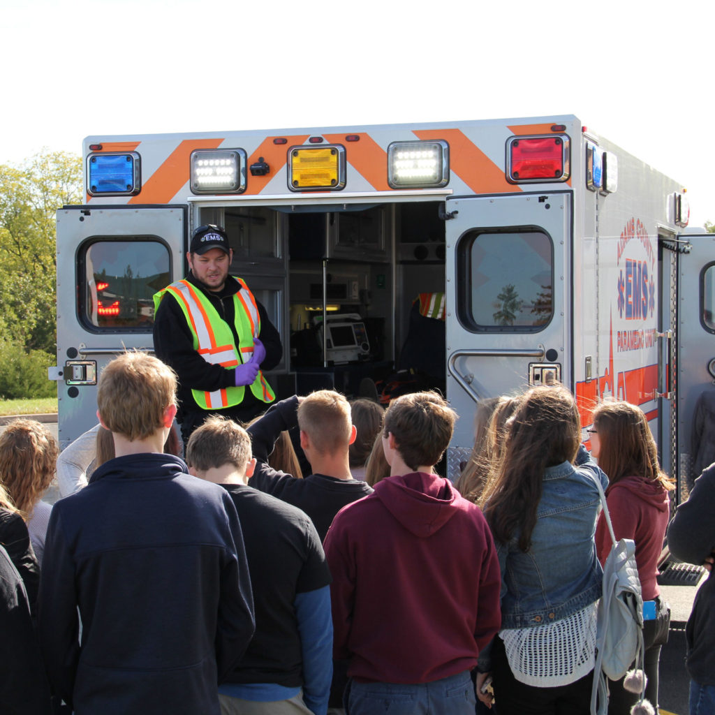 Group of students next to an ambulance