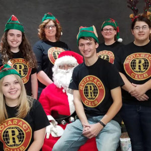 Rotaract Club students sit on Santa's lap