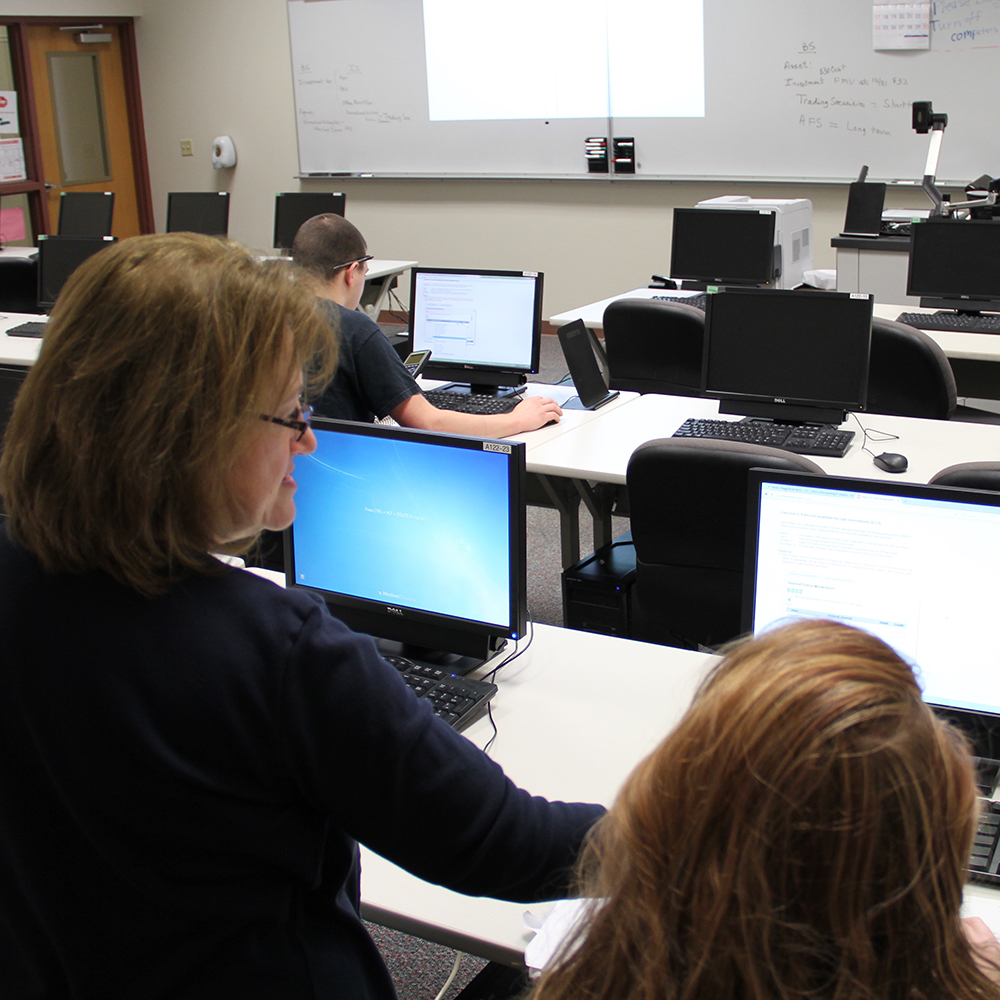 instructor helping a student on the computer