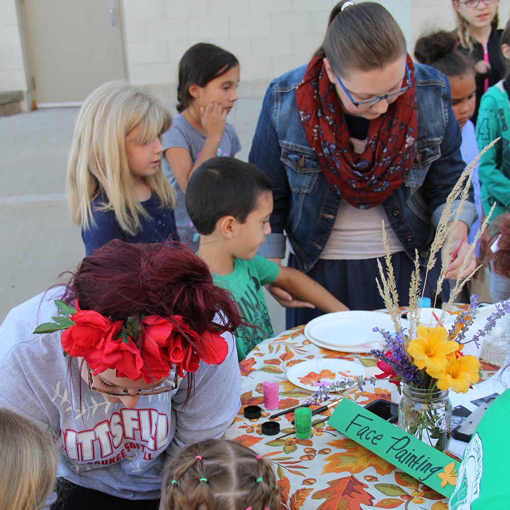 Children participating in face painting