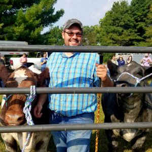 Student judging two cows