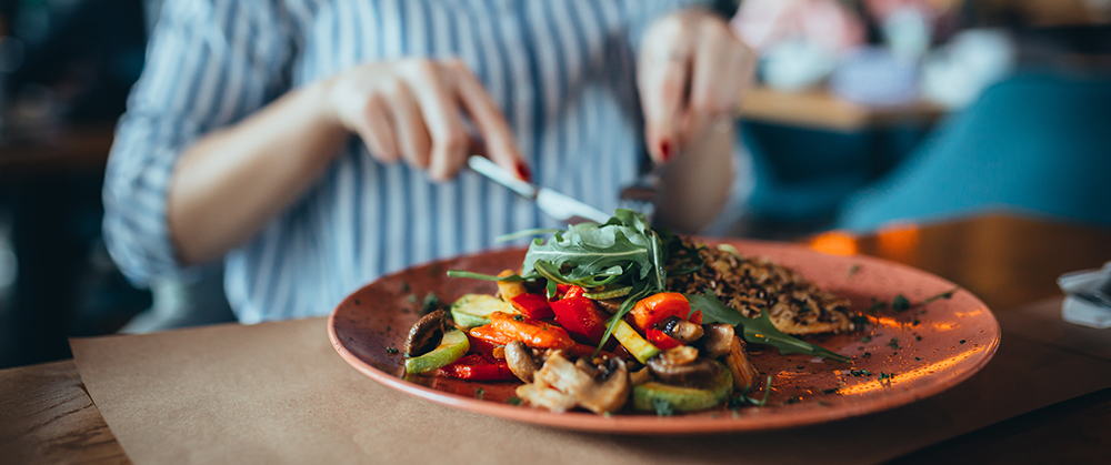 close up of woman in restaurant eating restaurants