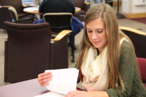 Student looks over her notes in the library