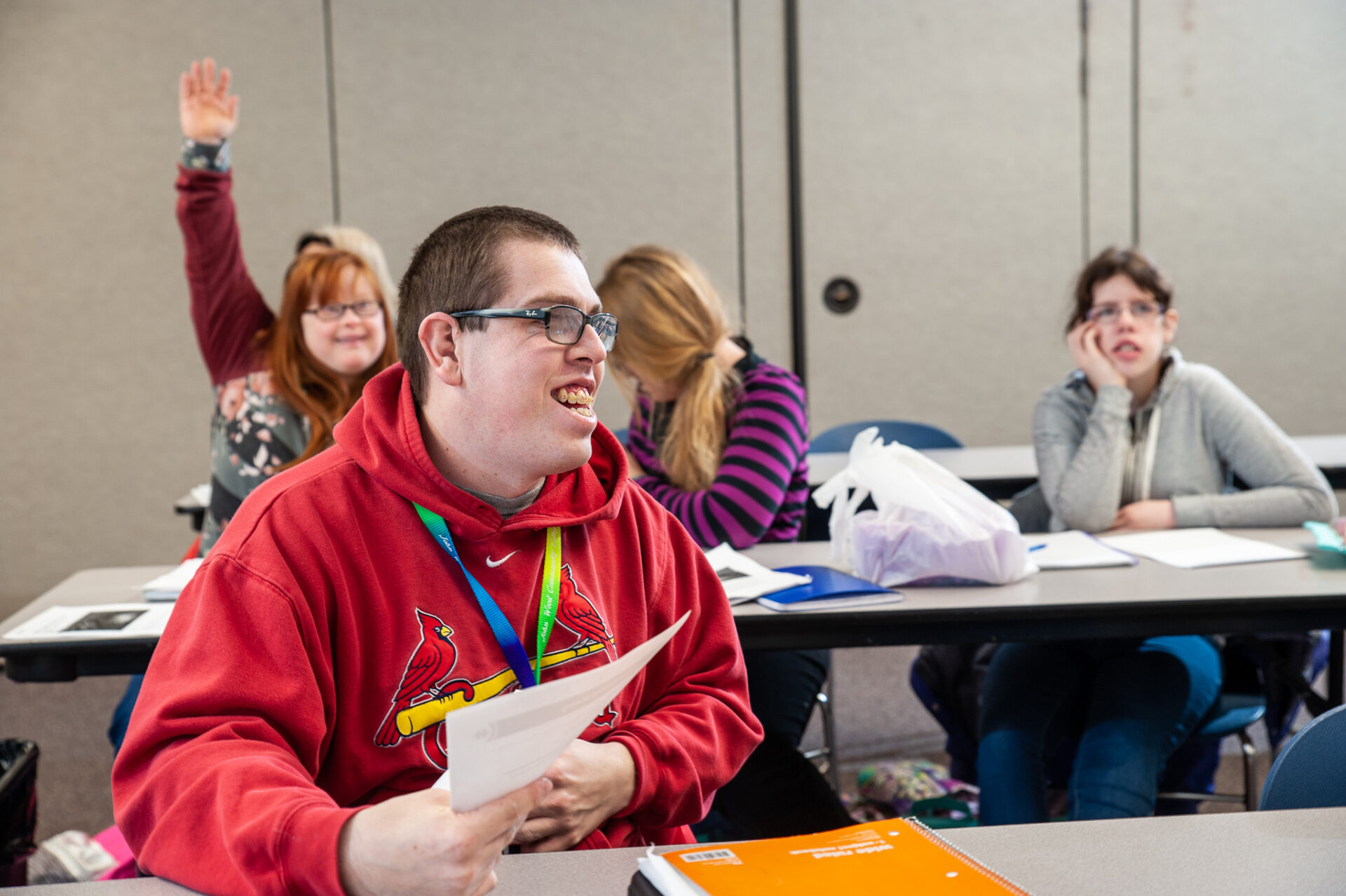 College for life students raise their hand to answer the professor's question