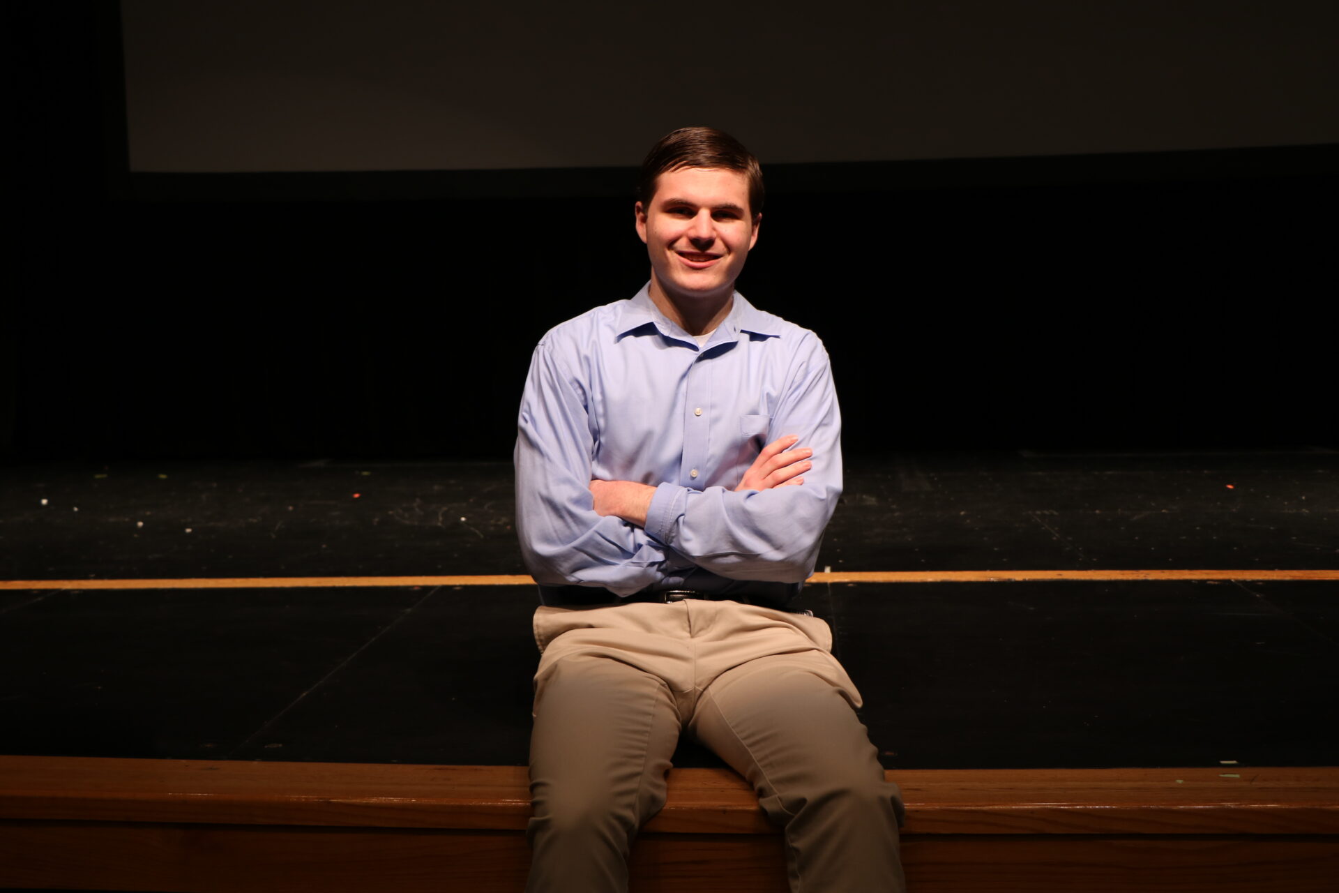 Evan Conover sitting on the stage
