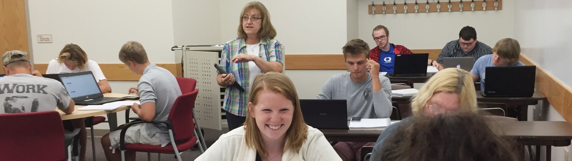 Professor offers instructions to groups of students