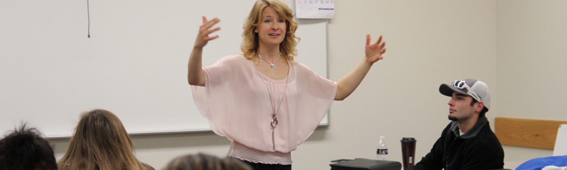 Psychology professor excitedly explains concept in front of class