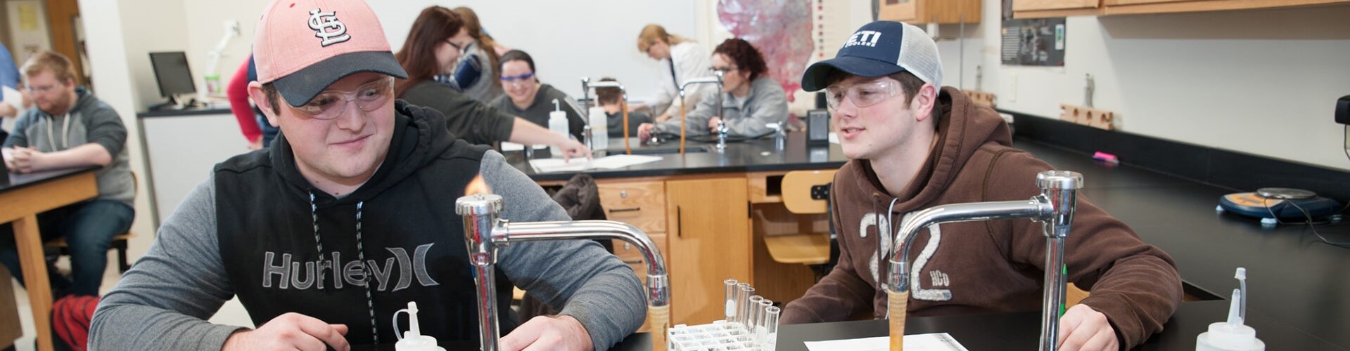 Two students work on an experiment in a chemistry lab