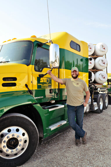 Mark Sanders in front of a semi truck that he learned to drive at JWCC.