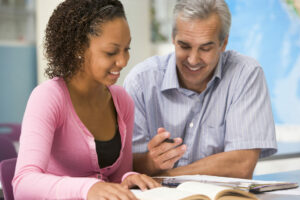 Teacher helping a student.