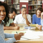 Mature students working in library