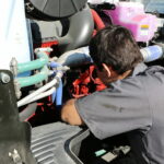 A JWCC Student learning to work on a diesel engine.