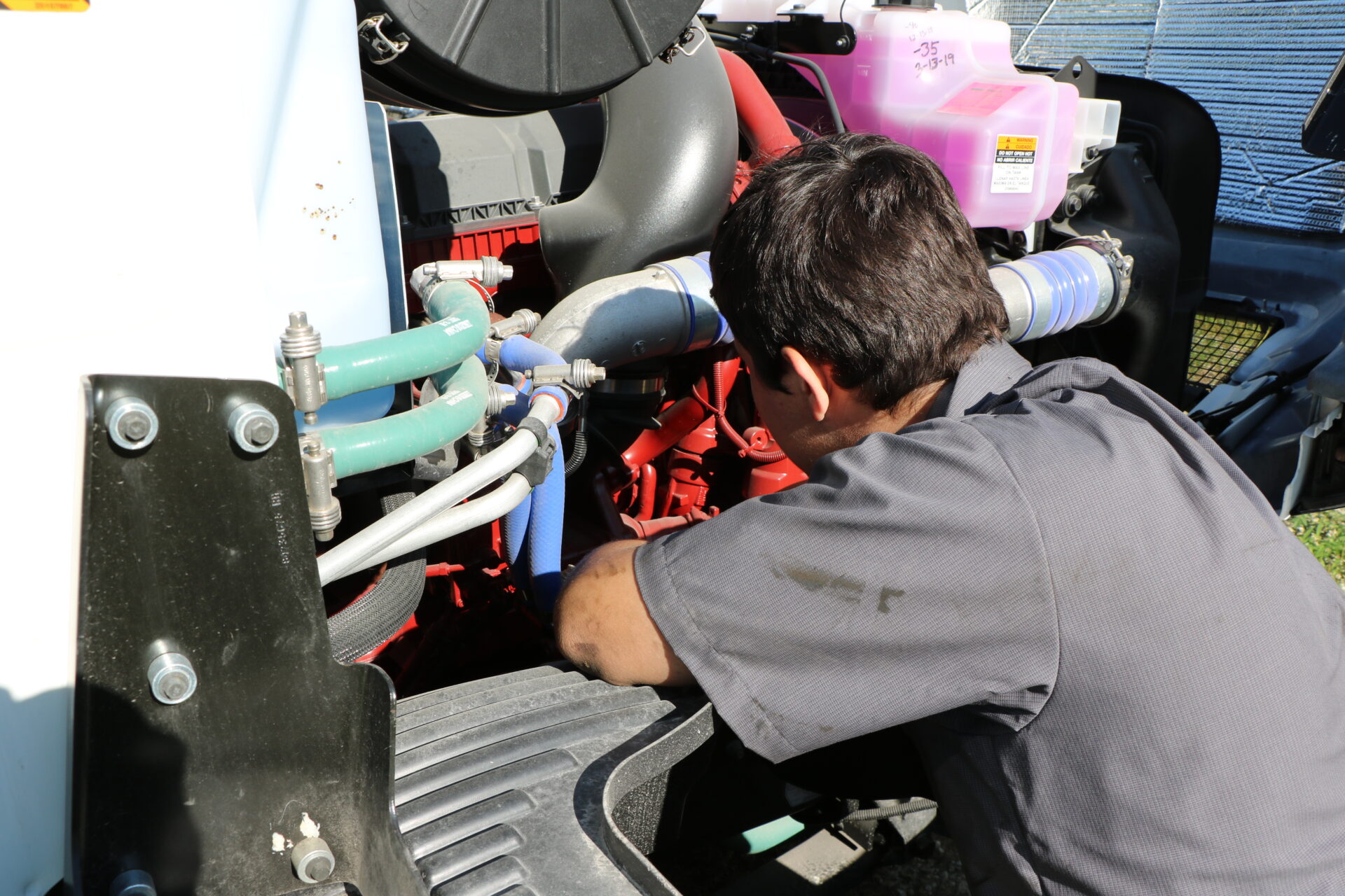 A JWCC Student learning to work on a diesel engine.