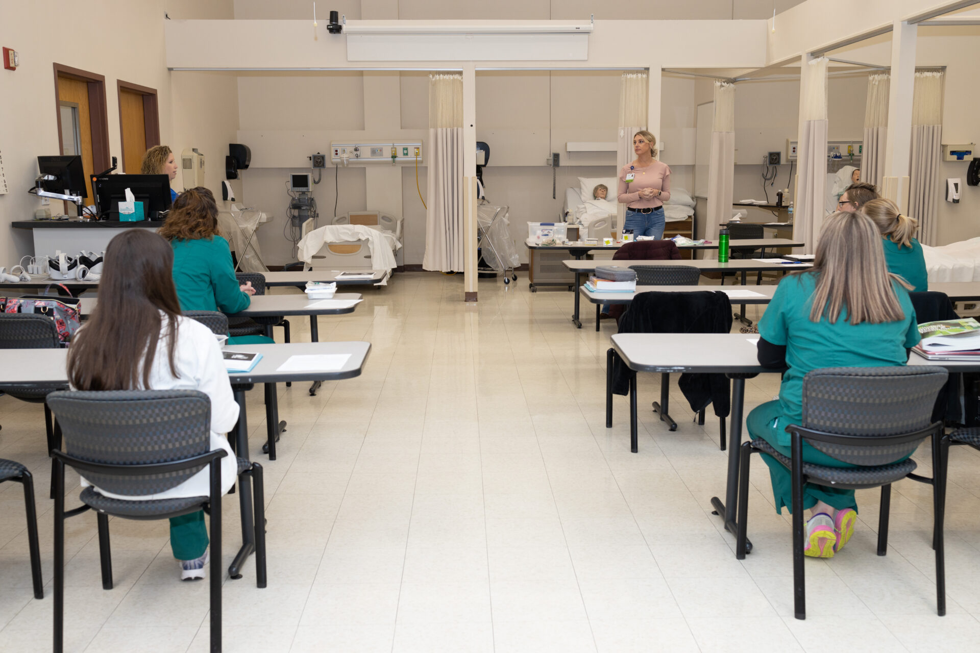 Several nursing students listen attentively to lecture
