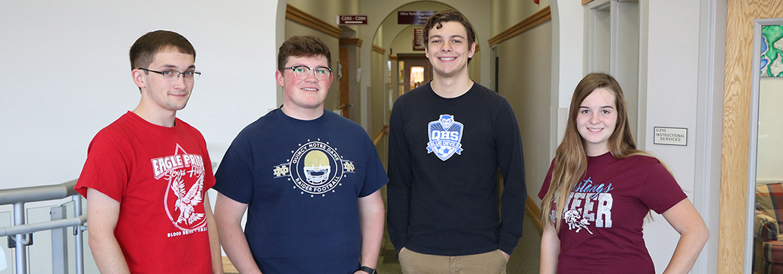 Students smile with their high school tshirts