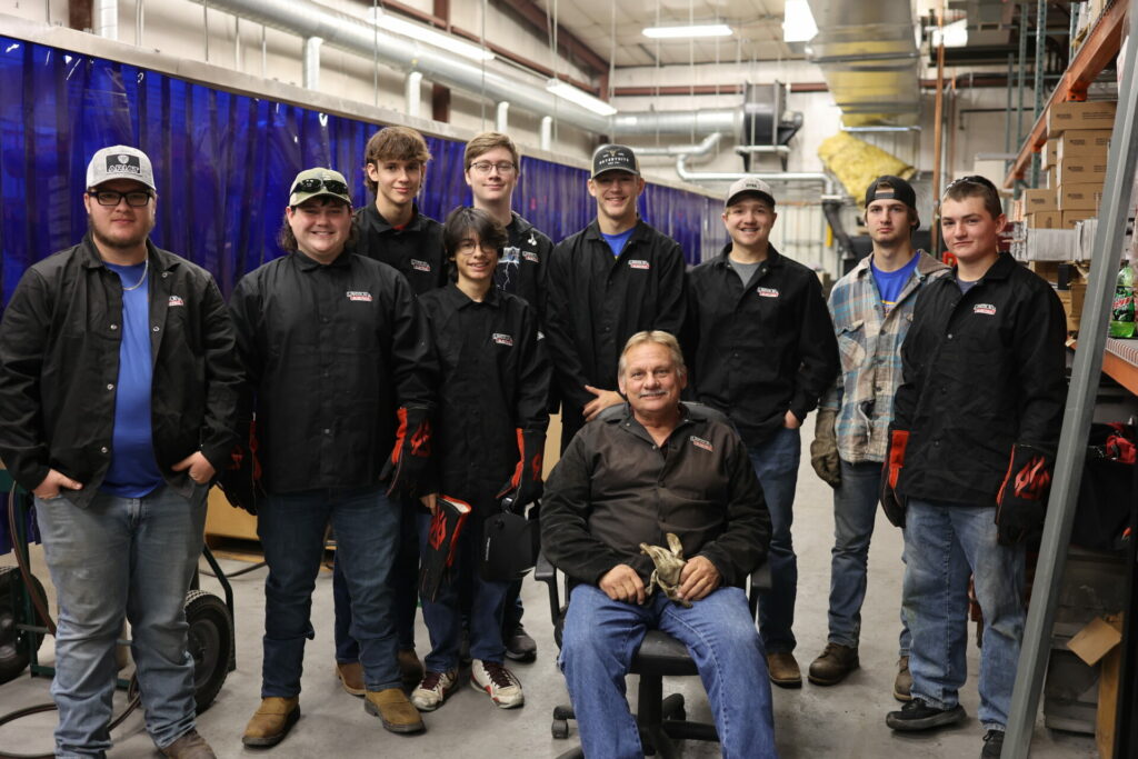Welding students pose for a smile