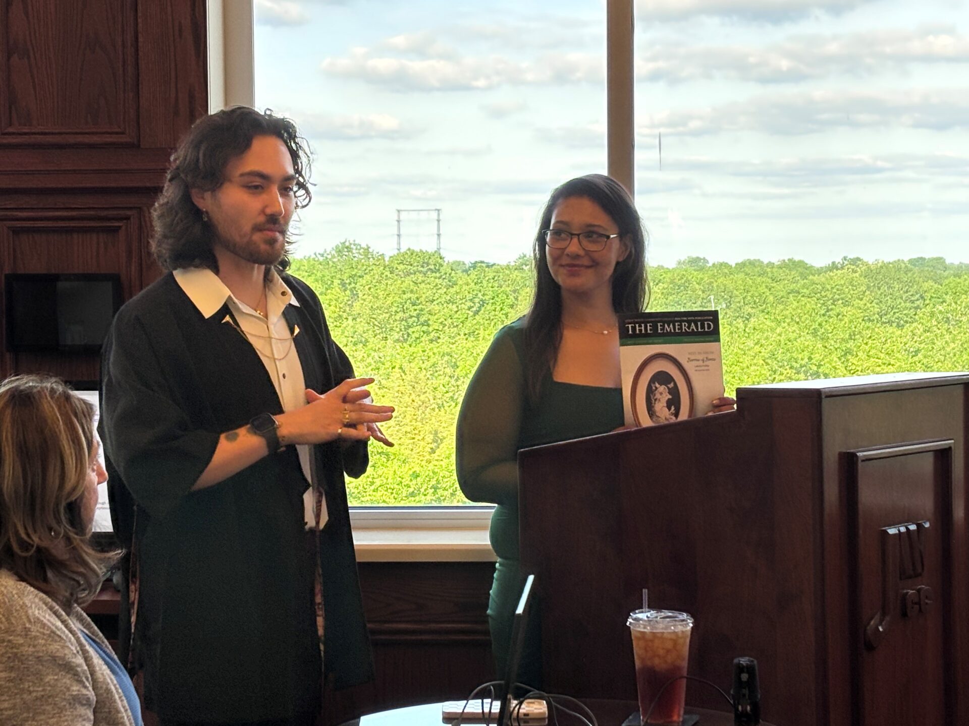 L/R: JWCC Assistant Professor of Visual and Fine Arts Austin Roberts briefs John Wood Community College Trustees on the College’s annual Student Creative and Visual Arts Awards. Tae’ana Roan read her award-winning poem, “Behind the Mask,” during the board meeting. Students’ creative writing and visual art is highlighted each year in The Emerald publication that can be viewed at jwcc.edu/programs/fine-arts.